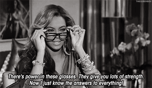 Beyonce putting on glasses